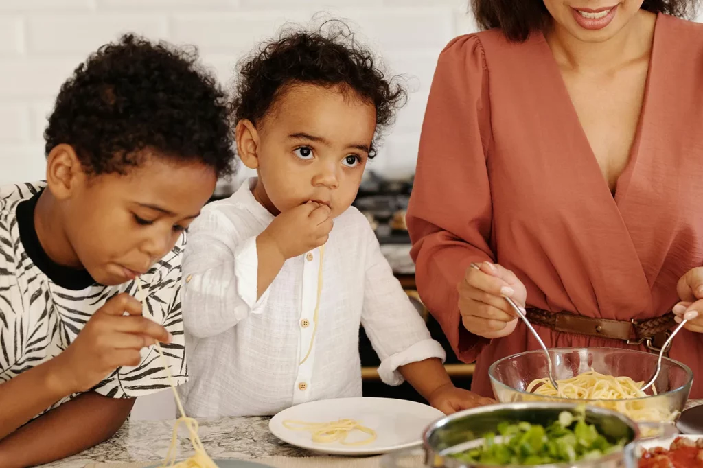 Mom, picky kid, and picky toddler eating a healthy meal together