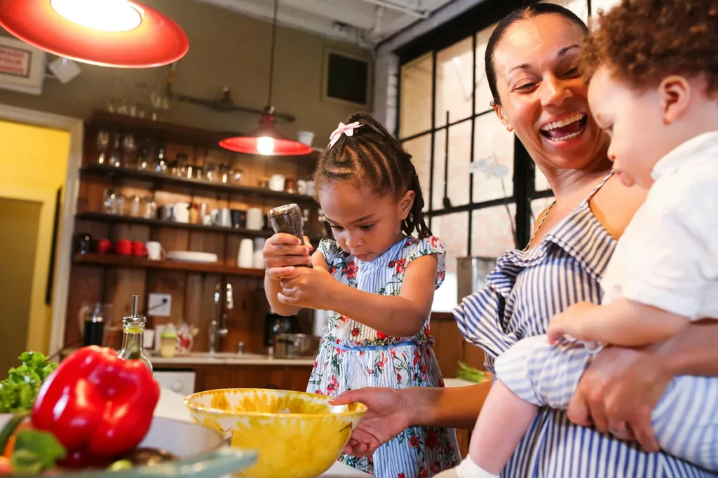 Mom and picky child and picky toddler preparing healthy foods together